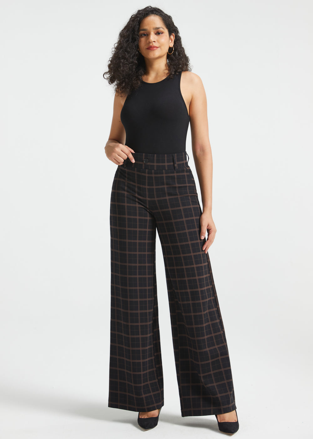Woman wearing Black Brown Plaid high-waisted wide-leg Dress Pant Yoga Pants with a black sleeveless top and black heels, full front view