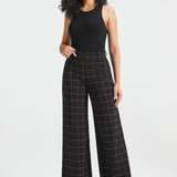 Woman wearing Black Brown Plaid high-waisted wide-leg Dress Pant Yoga Pants with a black sleeveless top and black heels, full front view