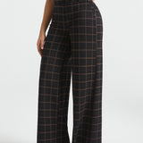Three-quarter view of woman wearing Black Brown Plaid high-waisted wide-leg Dress Pant Yoga Pants with black heels