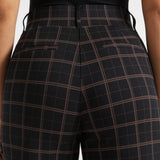 Close-up rear view of Black Brown Plaid high-waisted pants showing the tailored back seaming and faux welt pockets