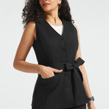 Woman wearing black button-front ponte vest with V-neckline, tie waist and hand in front pocket