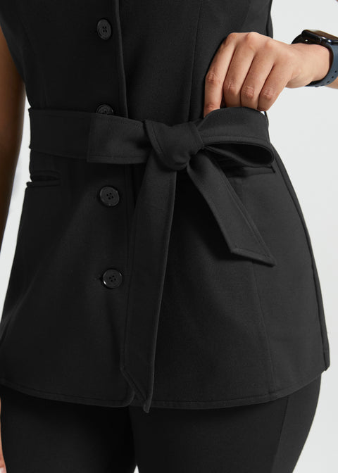 Close-up of black ponte vest showing removable self-tie belt and button-front closure