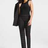 Full-length woman wearing Black Brown Plaid straight-leg Dress Pant Yoga Pants with a black sleeveless top and matching blazer over her shoulder