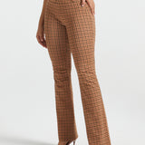 Woman wearing Camel Mini Houndstooth straight-leg Dress Pant Yoga Pants with a black sleeveless top and brown heels, front view
