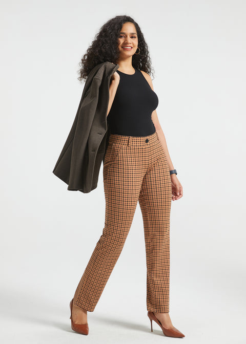 Woman wearing Camel Mini Houndstooth straight-leg Dress Pant Yoga Pants with a black top, brown heels and blazer draped over her shoulder
