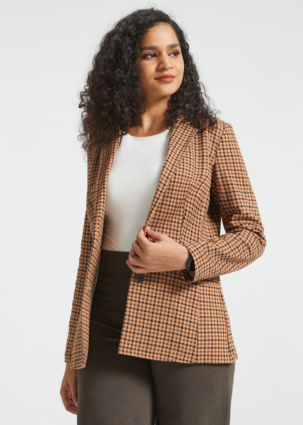 Woman wearing Camel Mini Houndstooth Classic Blazer open over a white top with brown pants
