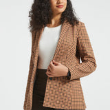Woman wearing Camel Mini Houndstooth Classic Blazer open over a white top with brown pants