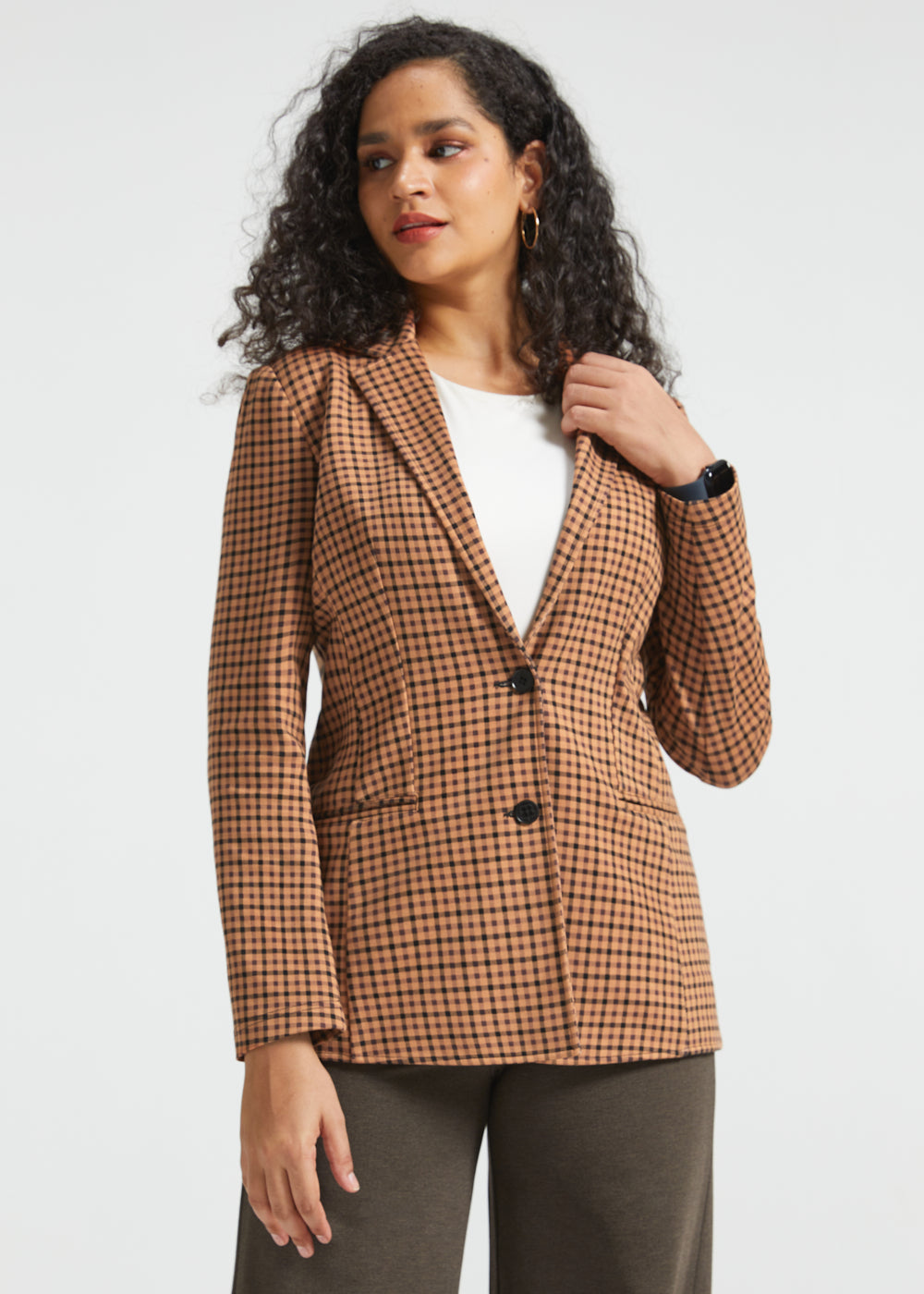 Woman wearing Camel Mini Houndstooth Classic Blazer buttoned over a white top, front three-quarter view