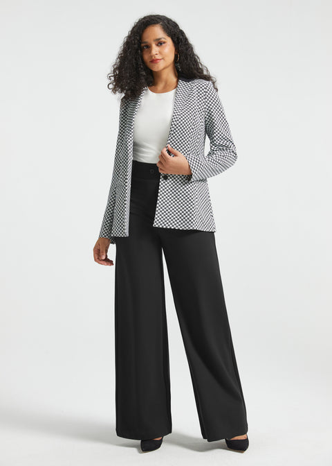 Full-length front view of woman wearing the Black Ivory Catstooth Classic Blazer open with a white top and black wide-leg pants