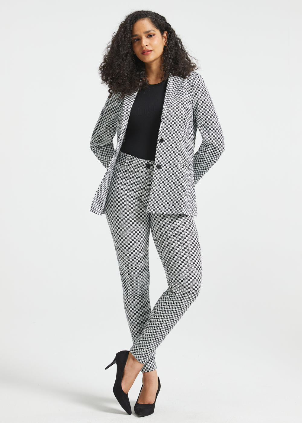 Full-length woman wearing the Black Ivory Catstooth Classic Blazer with matching slim pants and black heels