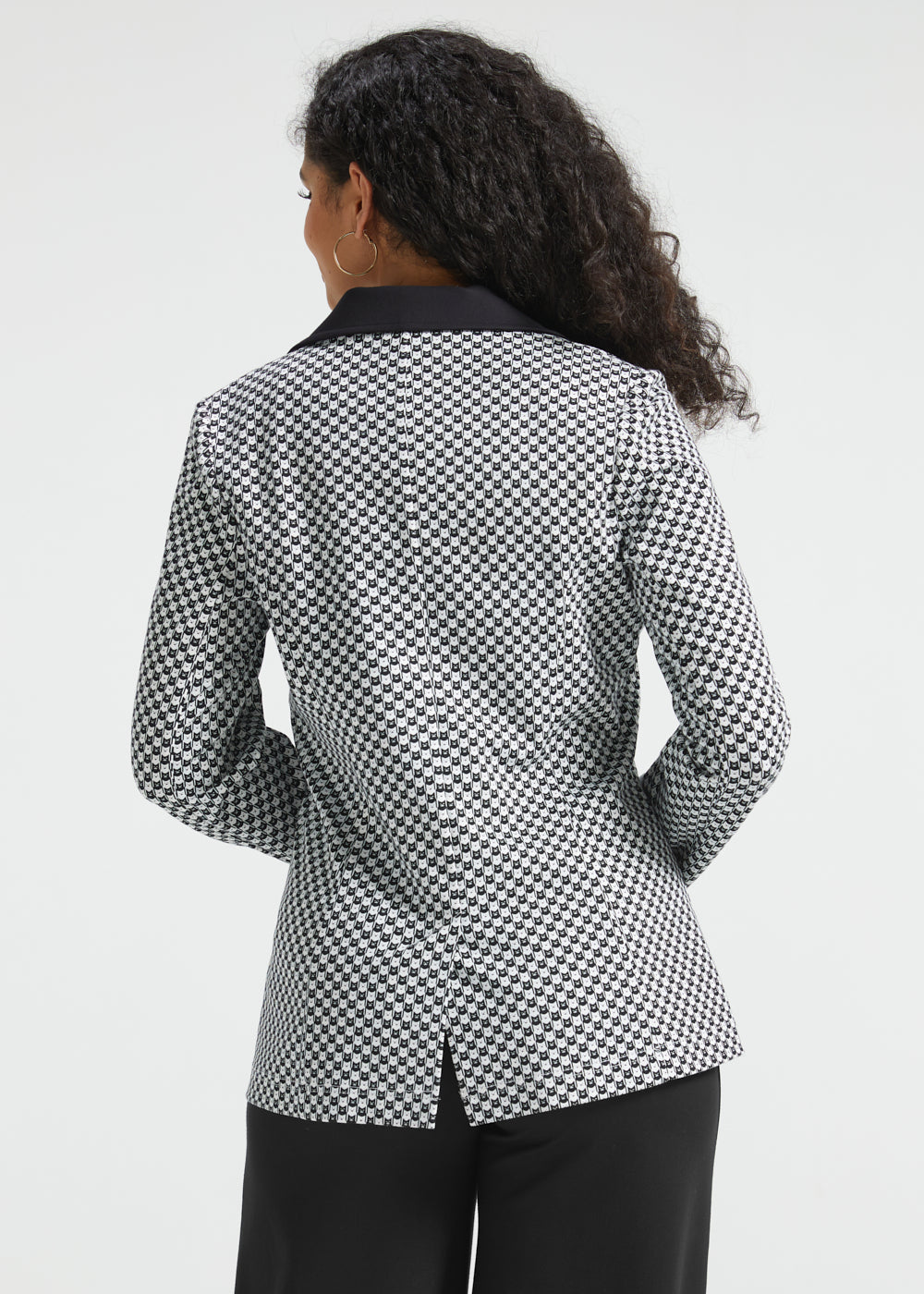 Back view of woman wearing the Black Ivory Catstooth Classic Blazer showing the contrast black collar and center back vent