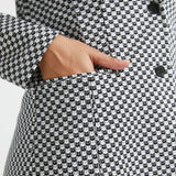 Close-up of hand inside the functional welt pocket of the Black Ivory Catstooth Classic Blazer