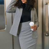 Woman wearing the Black Ivory Catstooth high-waist pencil skirt with matching blazer and black turtleneck in an office setting
