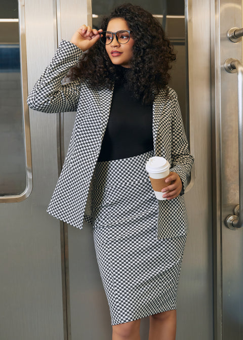 Woman wearing the Black Ivory Catstooth high-waist pencil skirt with matching blazer and black turtleneck in an office setting
