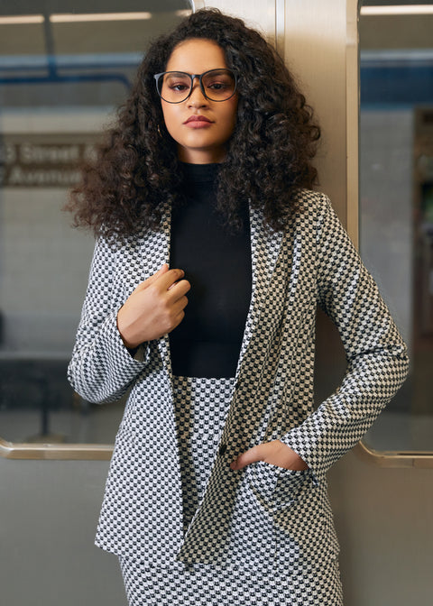 Woman wearing the black and ivory cat print Classic Blazer over a black turtleneck with matching skirt in an office setting