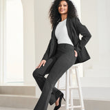 woman wearing matching charcoal gray suit jacket and bootcut leg pants