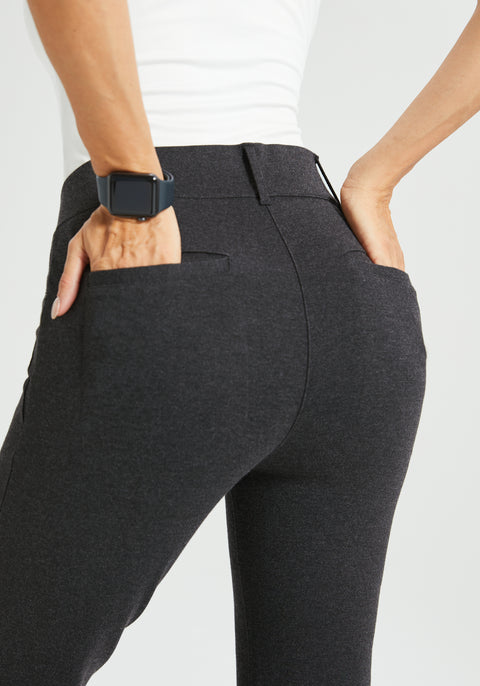 Person wearing dark gray pants with a white background